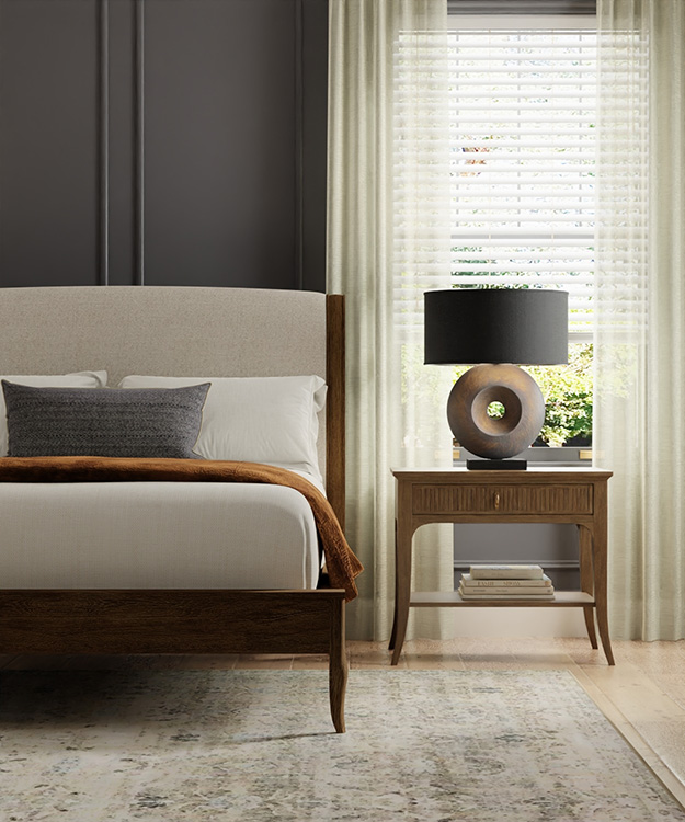 white faux wood blind in bedroom layered with curtains. traditional modern style with charcoal walls